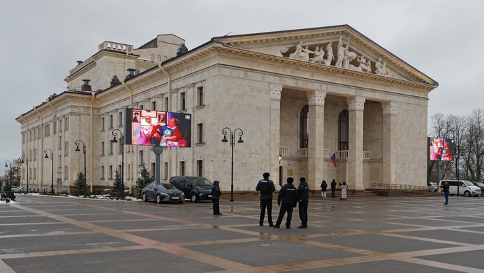 Police officers stand guard in front of the theatre, which was destroyed in the course of the Russia-Ukraine military conflict and later restored, in Mariupol, a Russian-controlled city of Ukraine, December 28, 2025. REUTERS/Alexander Ermochenko