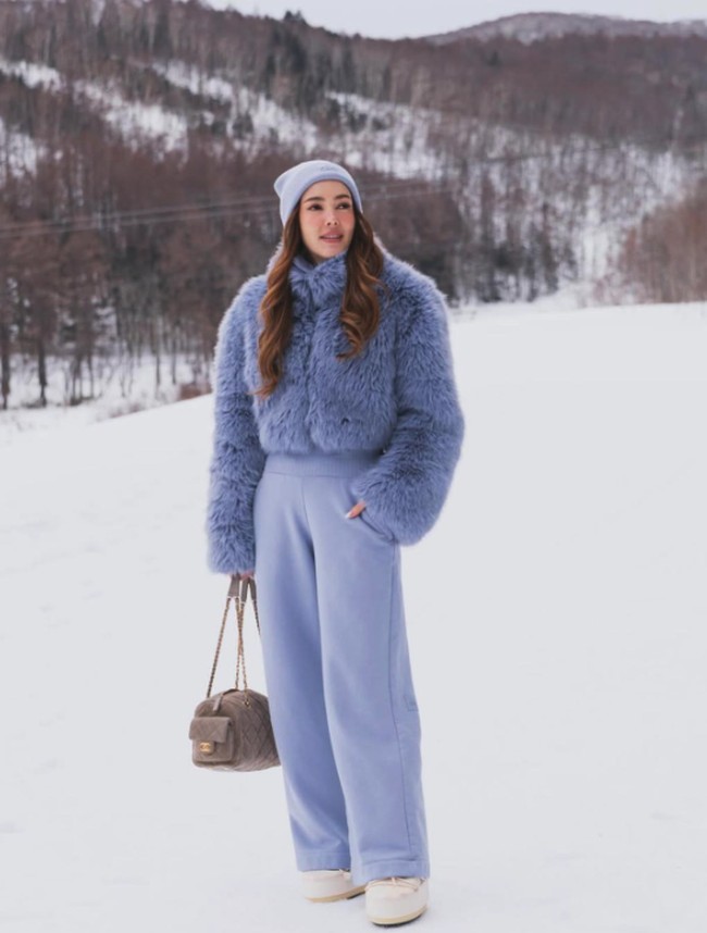 Cathy Sharon berbagi foto liburan di Jepang saat bermain salju. Ia tampak cantik dan stylish mengenakan setelan dalam nuansa biru muda. Foto: Dok. Instagram