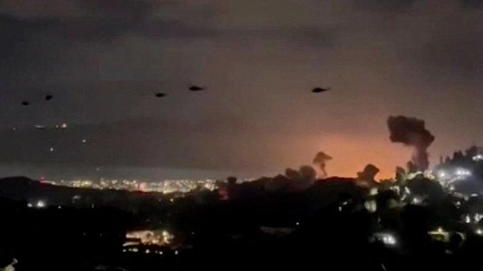 Helicopters fly past plumes of smoke rising from explosions, in Caracas, Venezuela, January 3, 2026 in this screen grab obtained from video obtained by Reuters. Video Obtained by Reuters/via REUTERS  THIS IMAGE HAS BEEN SUPPLIED BY A THIRD PARTY. NO RESALES. NO ARCHIVES. NEWS USE ONLY. THIS PICTURE WAS PROCESSED BY REUTERS TO ENHANCE QUALITY. AN UNPROCESSED VERSION HAS BEEN PROVIDED SEPARATELY.  VERIFICATION: - Mountains, towers and buildings match satellite and file imagery of Caracas  - Date verified by multiple corroborating videos of strikes on Caracas      TPX IMAGES OF THE DAY