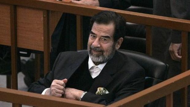 IRAQ-SADDAM-TRIAL Ousted Iraqi President Saddam Hussein smiles in court during the 'Anfal' genocide trial in Baghdad, 06 December 2006. The trial continues on charges of murdering Kurds during the 1987-88 Anfal campaign. A smiling Saddam Hussein was back in court today for his genocide trial despite earlier demanding to be excused from a process that he describes as a