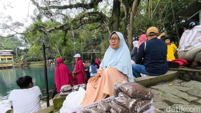 Uti, penjual pakan ikan di Telaga Biru Cicerem Kuningan.