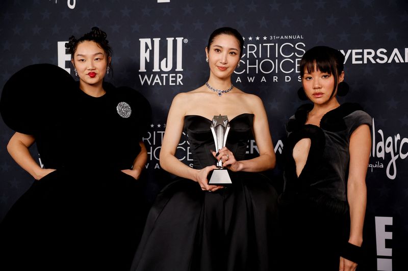 Audrey Nuna, EJAE, and Rei Ami pose with the Best Song award for 