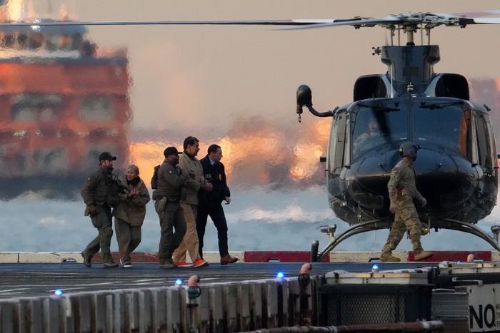Law enforcement officials move captured Venezuelan President Nicolas Maduro and his wife Cilia Flores out of the helicopter, as Maduro heads towards the Daniel Patrick Manhattan United States Courthouse for an initial appearance to face U.S. federal charges including narco-terrorism, conspiracy, drug trafficking, money laundering and others in New York City, U.S., January 5, 2026. REUTERS/Adam Gray
