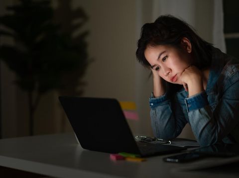 Ilustrasi lembur Candid of young asian single female student work late night stress out with project research problem on computer laptop or notebook at home office. Asian people occupational burnout syndrome concept.