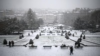 Anak-anak dan remaja tampak bermain seluncur salju serta membuat manusia salju di area Montmartre, menciptakan suasana ceria di tengah cuaca dingin. REUTERS/Sarah Meyssonnier