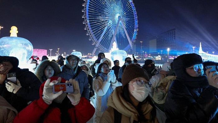 People watch fireworks at the annual Harbin International Ice and Snow Sculpture Festival, in Harbin, Heilongjiang Province, China, January 5, 2026. REUTERS/Go Nakamura