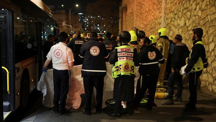 Emergency responders attend the scene of where, according to Israel's ambulance service, a person was killed in a collision involving a bus and several pedestrians, during a protest by Ultra-Orthodox Jewish men against pressure to conscript men from their community into Israel's military, in Jerusalem, January 6, 2026. REUTERS/Ammar Awad