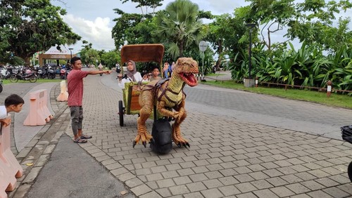 Keseruan wisatawan di Pantai Kuta Mandalika, Lombok Tengah, mengendarai Dino Dokar. (Dok Direktur Manna Lika Studio, Melissa Yohana)