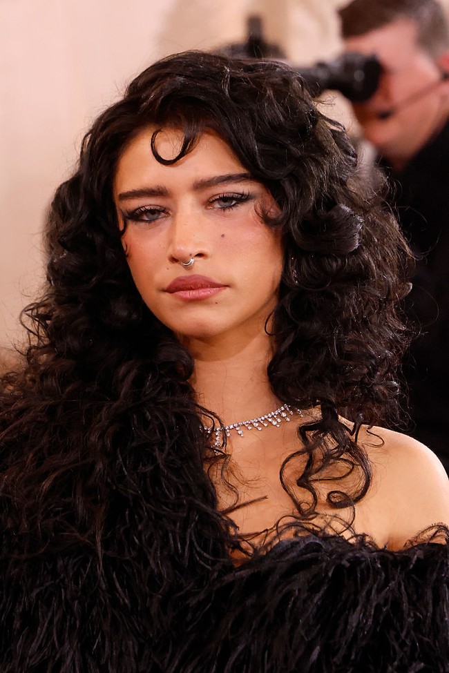 Odessa A’zion   Aktris Marty Supreme ini tampil dengan makeup terinspirasi era 80-an, lengkap dengan alis tebal. Rambut ikalnya yang khas menambah kesan retro-modern. Foto: dok. Getty Images