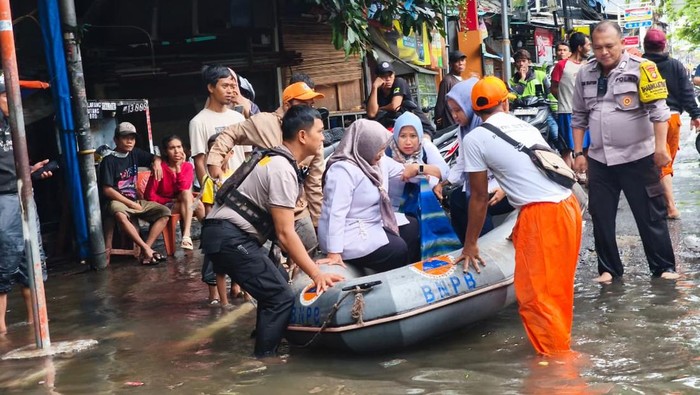 Respons Cepat Polisi-PPSU Evakuasi Bu Guru Kecelakaan Saat Banjir di Jakut