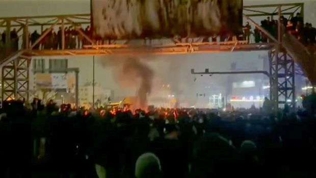 In this frame grab from footage circulating on social media from Iran shows protesters taking to the streets despite an intensifying crackdown as the Islamic Republic remains cut off from the rest of the world in Tehran, Iran, Friday, Jan. 9, 2026.(UGC via AP)