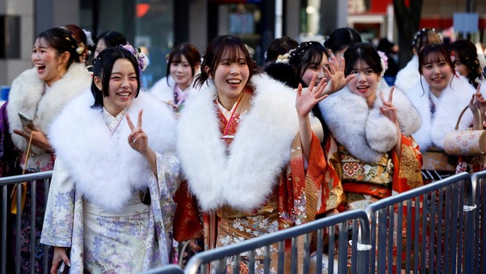 Kimono-clad young women getures as they walk on their way to a venue during their Coming of Age Day celebration ceremony in Yokohama, Japan, January 12, 2026. REUTERS/Manami Yamada