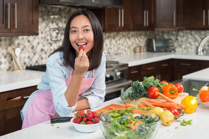 Eurasian Women Preparing A Healthy Meal in the kitchen.