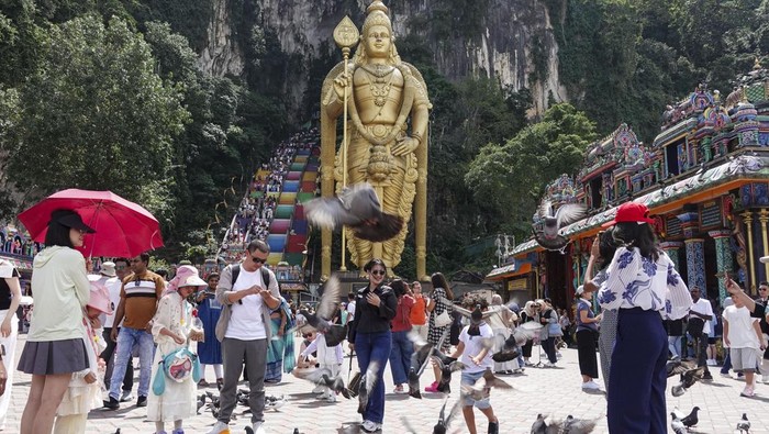 People visit the Batu Caves temple complex on the outskirts of Kuala Lumpur, Malaysia