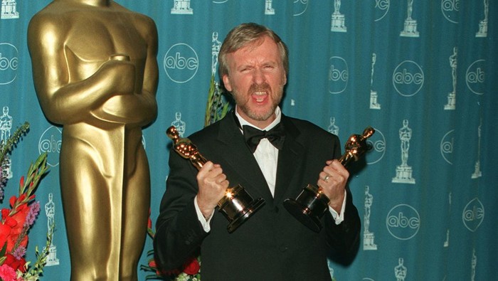 (Original Caption) James Cameron with the Oscars for best film and best director for Titanic. (Photo by Frank Trapper/Corbis via Getty Images)