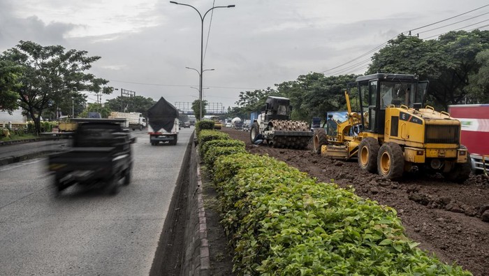 Pekerja memadatkan tanah menggunakan alat berat dalam proyek peninggian Jalan Pantura Kaligawe Raya di Semarang, Jawa Tengah, Kamis (15/1/2026). Balai Besar Pelaksanaan Jalan Nasional (BBPJN) Jateng-DIY Kementerian Pekerjaan Umum melakukan proyek peninggian jalan pada KM 3+900 hingga KM 4+600 jalur utama pantura Semarang-Surabaya untuk meningkatkan kapasitas jalan serta mengantisipasi genangan dan banjir rob akibat penurunan muka tanah yang ditargetkan selesai pada Maret 2026. ANTARA FOTO/Aprillio Akbar