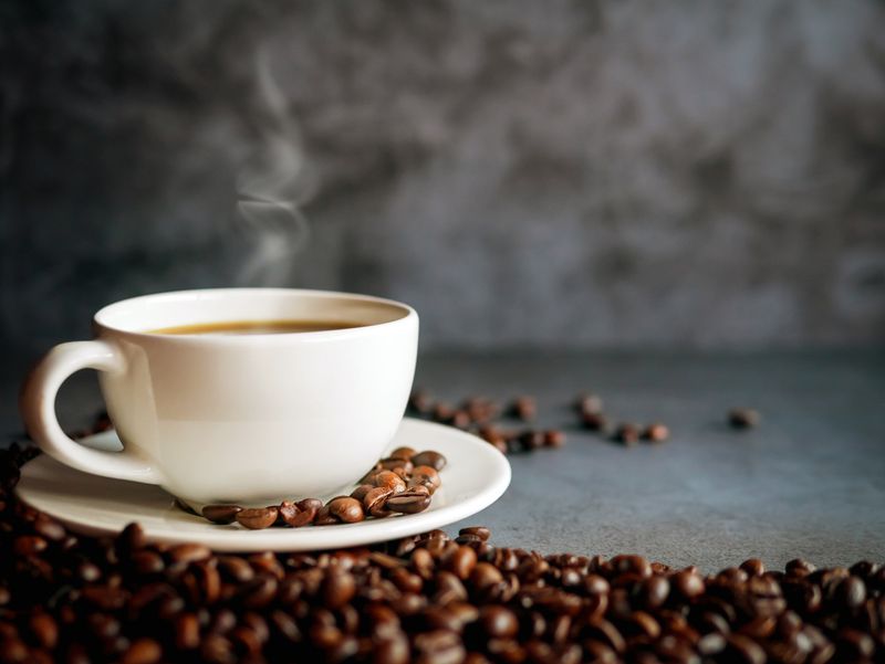 Coffee cup and coffee beans on gray background, Black coffee cup aromatic