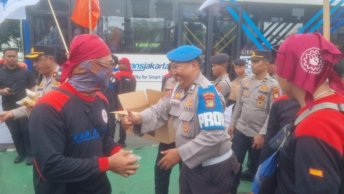 Polisi Bagi Air Mineral dan Snack ke Massa Buruh yang Demo di DPR