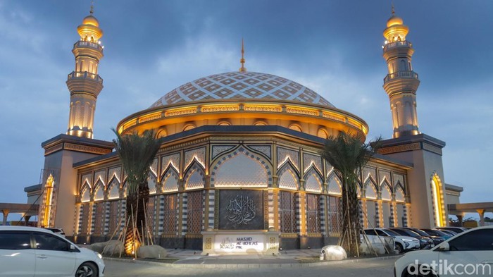 Masjid Al-Ikhlas berada di kawasan Riverwalk Island, Pantai Indah Kapuk 2 (PIK 2). Pada malam hari, sistem pencahayaan eksterior menonjolkan bentuk kubah utama dan struktur bangunan secara jelas dari kejauhan.