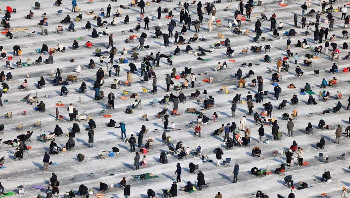 People fish for trout on a frozen river during the Hwacheon Ice Festival, south of the demilitarized zone (DMZ) separating the two Koreas, in Hwacheon, South Korea, January 17, 2026. REUTERS/Kim Soo-hyeon