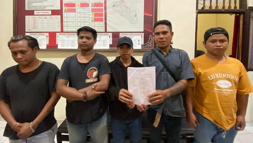 Para pihak yang terlibat pengeroyokan di Banjar Dinas Pangussari, Desa Tigawasa, Kecamatan Banjar, Buleleng, menunjukkan surat tanda perdamaian seusai dimediasi, Kamis (15/1/2026). (Dok. Polres Buleleng)