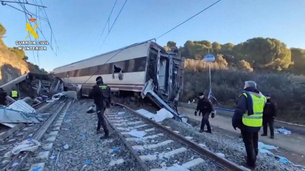 Emergency personnel walk at the site of a deadly collision of two high-speed trains near Adamuz, in Cordoba, Spain, January 19, 2026 in this screengrab taken from a video. Guardia Civil/via Reuters TV/Handout via REUTERS    THIS IMAGE HAS BEEN SUPPLIED BY A THIRD PARTY. MUST NOT OBSCURE LOGO.