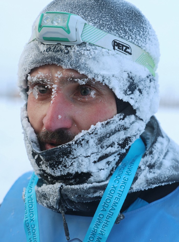 An athlete reacts after crossing the finish line of the 