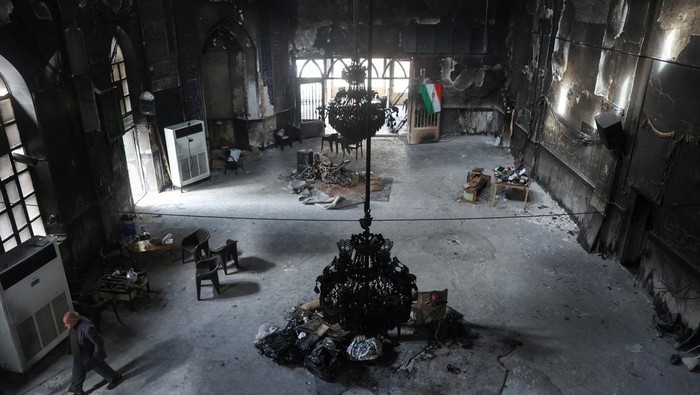 Iranian clerics stand in the Islamic seminary that was burned during Iran's protests, in Tehran, Iran, January 21, 2026. Majid Asgaripour/WANA (West Asia News Agency) via REUTERS ATTENTION EDITORS - THIS PICTURE WAS PROVIDED BY A THIRD PARTY     TPX IMAGES OF THE DAY