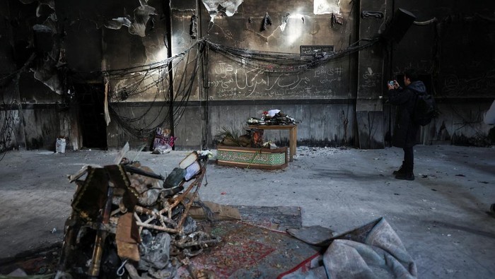 Iranian clerics stand in the Islamic seminary that was burned during Iran's protests, in Tehran, Iran, January 21, 2026. Majid Asgaripour/WANA (West Asia News Agency) via REUTERS ATTENTION EDITORS - THIS PICTURE WAS PROVIDED BY A THIRD PARTY     TPX IMAGES OF THE DAY