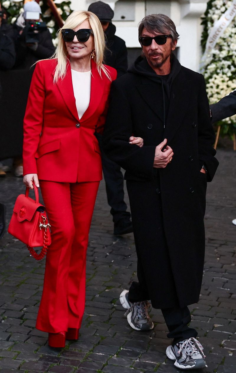 Donatella Versace and Pierpaolo Piccioli outside the PM23 foundation, where late fashion designer Valentino Garavani lies in state following his death at the age of 93, in Rome, Italy, January 22, 2026. REUTERS/Yara Nardi