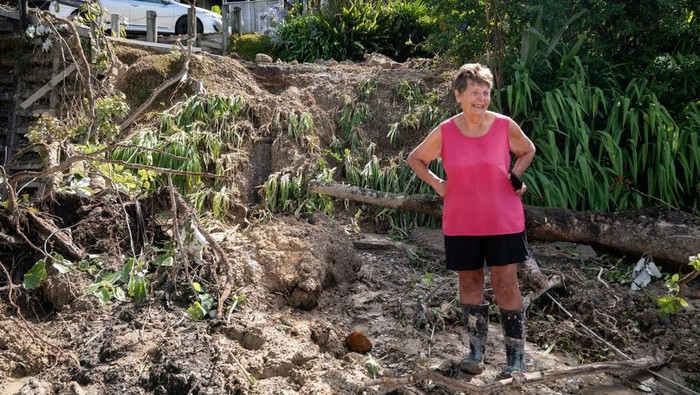 Residents from Tairua clean up a land slip following the recent storm that struck New Zealand’s North Island, January 23, 2026. Corey Fleming/Pool via REUTERS