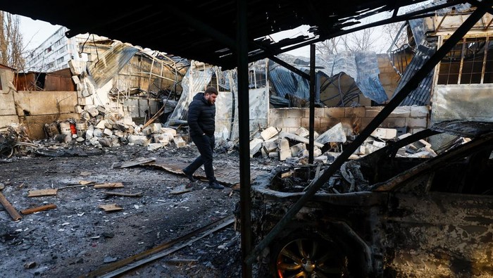 A resident inspects a compound of car workshop and garage hit during Russian overnight drone and missile strikes, amid Russia's attack on Ukraine, in Kyiv, Ukraine January 24, 2026. REUTERS/Valentyn Makarenko