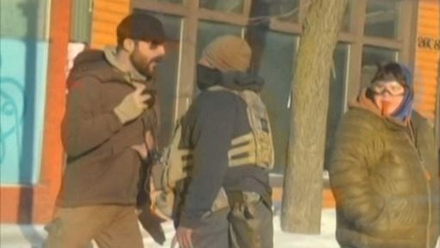 This screengrab of video footage shot by @dangjessie, shows Alex Pretti (L) and a federal immigration agent (C) before he was shot dead in Minneapolis, Minnesota, on January 24, 2026. Federal agents shot and killed Alex Pretti, a 37-year-old ICU nurse, early January 24 while scuffling with him on an icy roadway in the Midwestern city, less than three weeks after an immigration officer fired on Renee Good, also 37, killing her in her car. (Photo by -UGC / @dangjessie/UGC / AFP) / RESTRICTED TO EDITORIAL USE  MANDATORY CREDIT   AFP PHOTO / @dangjessie   - NO MARKETING NO ADVERTISING CAMPAIGNS  DISTRIBUTED AS A SERVICE TO CLIENTS [ NO ARCHIVE ]