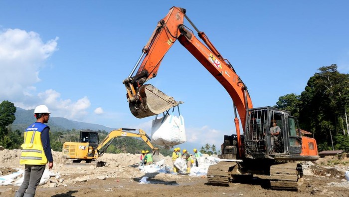 Foto udara alat berat milik Kementerian Pekerjaan Umum (PU) dan PT Hutama Karya (Persero) menyelesaikan pembangunan pengaman badan jalan dengan menggunakan karung besar berisi pasir dan batu di Desa Ketambe, Kecamatan Ketambe, Aceh Tenggara, Aceh, Selasa (27/1/2026). Data sementara posko tanggap darurat bencana hidrometeorologi Aceh menyebutkan sebanyak 2.507 lokasi atau titik jalan yang tersebar di 18 kabupaten dan kota mengalami rusak ringan hingga berat akibat bencana banjir bandang dan tanah longsor akhir November 2025 dan masih membutuhkan perbaikan untuk pemulihan trasportasi darat, koneksi antar wilayah serta membantu perekonomian masyarakat. ANTARA FOTO/Irwansyah Putra