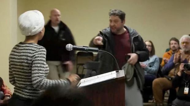 A man shouts at U.S. Representative Ilhan Omar (D-MN) after spraying her, during a town hall meeting days after a man identified as Alex Pretti was fatally shot by federal immigration agents trying to detain him, in Minneapolis, Minnesota, U.S., January 27, 2026, in a still image from video. REUTERS/Maria Alejandra Cardona