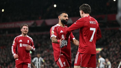 Liverpools German midfielder #07 Florian Wirtz (R) celebrates with Liverpools Egyptian striker #11 Mohamed Salah (C) after scoring their third goal during the English Premier League football match between Liverpool and Newcastle United at Anfield in Liverpool, north west England on January 31, 2026. (Photo by Paul ELLIS / AFP) / RESTRICTED TO EDITORIAL USE. No use with unauthorized audio, video, data, fixture lists, club/league logos or live services. Online in-match use limited to 120 images. An additional 40 images may be used in extra time. No video emulation. Social media in-match use limited to 120 images. An additional 40 images may be used in extra time. No use in betting publications, games or single club/league/player publications. /