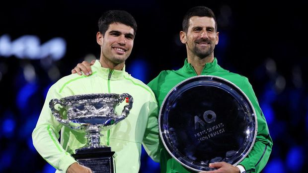 Tennis - Australian Open - Melbourne Park, Melbourne, Australia - February 1, 2026 Spain's Carlos Alcaraz poses with the trophy after winning the Australian Open men's singles alongside runner up Serbia's Novak Djokovic. Alcaraz becomes the youngest man to win all four grand slam titles. REUTERS/Edgar Su     TPX IMAGES OF THE DAY