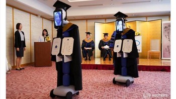 Mahasiswa “hadir” lewat iPad yang dipasang di robot—upacara kelulusan terasa futuristik sekaligus sepi. Foto: Boredpanda