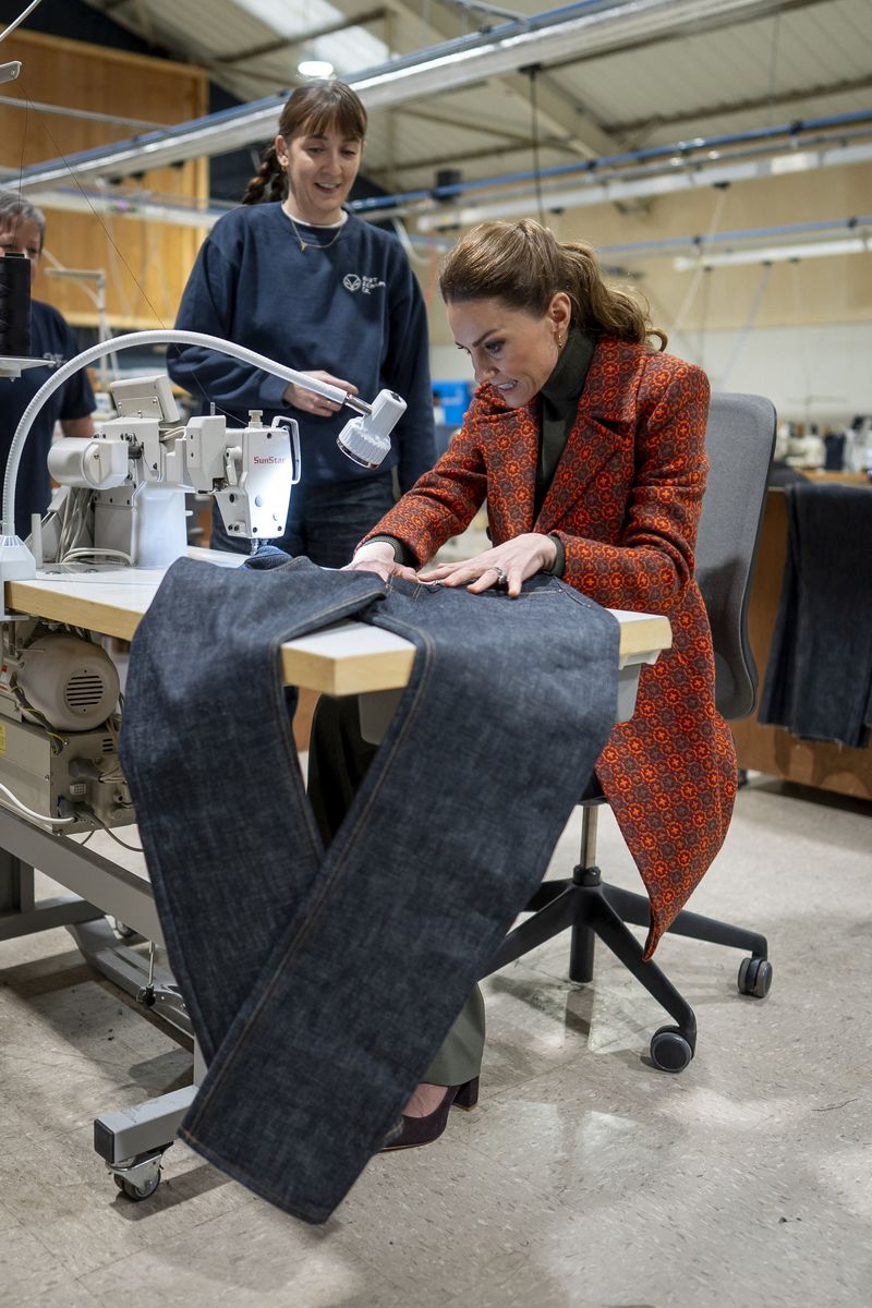 The Princess of Wales sews a 'Made in Wales' tag onto a pair of jeans during a visit to Hiut Denim, a family-owned company based in Cardigan, designing and manufacturing premium jeans entirely in the UK, on February 3, 2026 in Cardigan, Wales, Britain. Aaron Chown/Pool via REUTERS