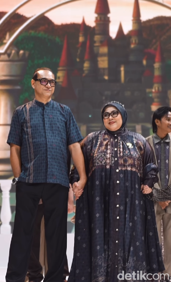 Nunung dan Iyan tampil serasi mengenakan busana muslim dari Zaskia Sungkar yang menonjolkan nuansa gelap elegan dengan perpaduan motif etnik khas dan detail kancing perak yang memberikan kesan mewah serta modern. Foto: Dok. Instagram @zaskiasungkar15.