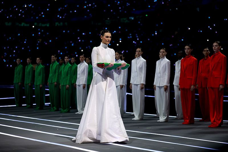 MILAN, ITALY - FEBRUARY 06: Vittoria Ceretti, flagbearer for Milano, caries the Italian flag during the opening ceremony of the Milano Cortina 2026 Winter Olympics at San Siro Stadium on February 06, 2026 in Milan, Italy. (Photo by Elsa/Getty Images)