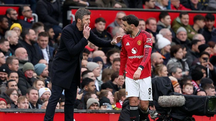 MANCHESTER, ENGLAND - JANUARY 17: Michael Carrick, Manager of Manchester United and Bruno Fernandes of Manchester United talk on the side line during the Premier League match between Manchester United and Manchester City at Old Trafford on January 17