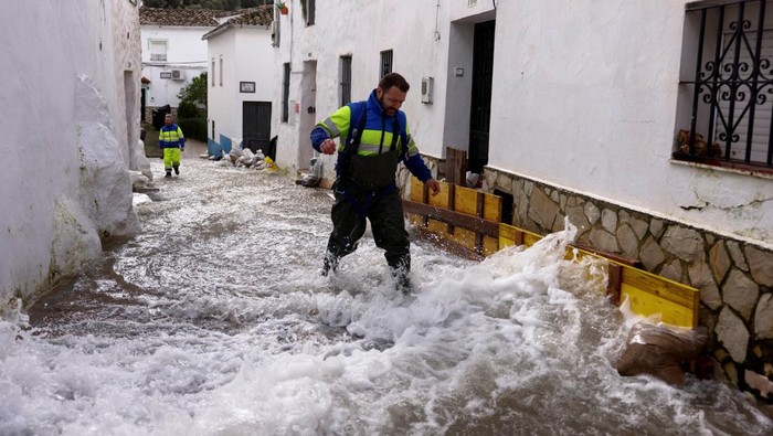 A man watches a flooded street after heavy rains, as Storm Marta hits parts of Spain, in Ubrique, Spain, February 8, 2026. REUTERS/Jon Nazca