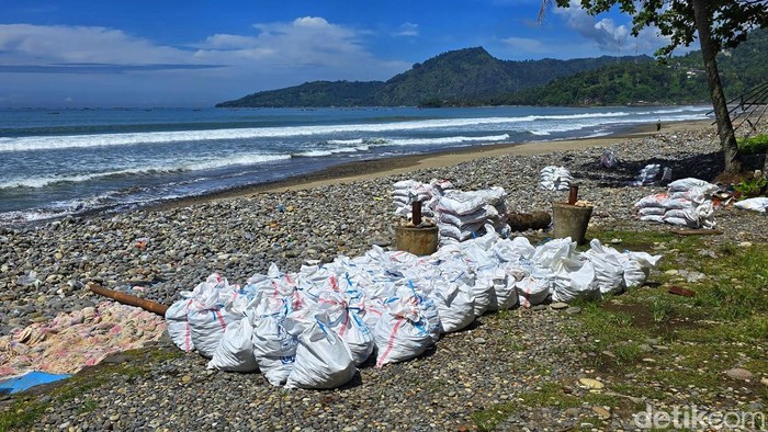 karung putih berisi koral di Pesisir Cisolok, Sukabumi.