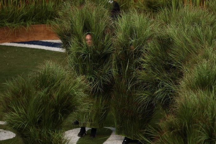 Performers dressed as Sugarcane grass step on stage for Puerto Rican singer Bad Bunny performance during Super Bowl LX Patriots vs Seahawks Apple Music Halftime Show at Levis Stadium in Santa Clara, California on February 8, 2026. (Photo by Patrick T. Fallon / AFP)