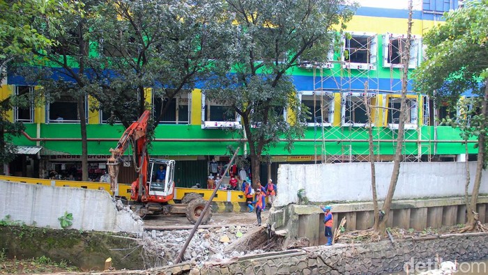 Petugas Sudin SDA Jakarta Selatan mengerjakan pembangunan turap Kali Pesanggrahan di kawasan Pasar Cipulir, Kebayoran Lama, Rabu (11/2/2026). Perbaikan dilakukan setelah turap amblas pada 18 Januari 2026 dan menyebabkan tembok pagar pasar ikut terdampak.