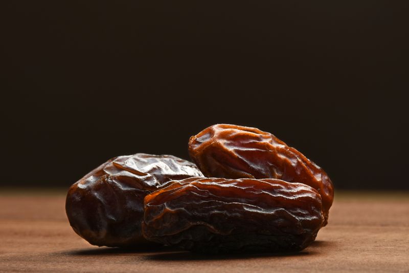 Dried date fruits still life concepts. Date fruits on the wooden surface with dark background and copy space