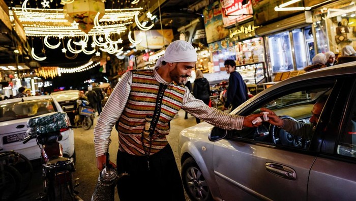 A vendor prepares trays of hot food at a street stall as Muslims prepare for the holy month of Ramadan in Damascus, Syria, February 18, 2026. REUTERS/Yamam Al Shaar