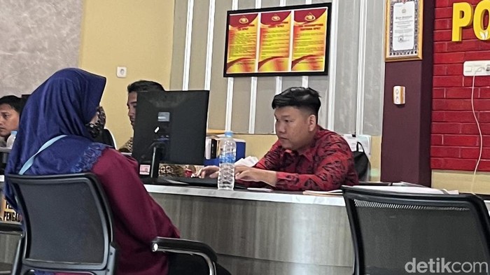 Wanita di Palembang saat membuat laporan polisi usai dianiaya suaminya.