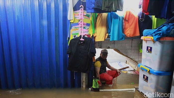 Aktivitas jual beli tetap berlangsung di Pasar Cipulir, Jumat (20/2/2026), meski genangan air mencapai sekitar 50 sentimeter akibat luapan Kali Pesanggrahan.